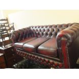 A maroon leather button back Chesterfield settee