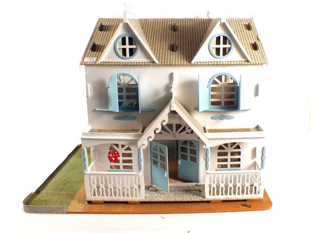 A blue and white painted dolls house plus a quantity of small furniture