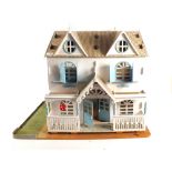 A blue and white painted dolls house plus a quantity of small furniture