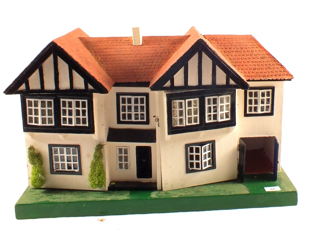 A wooden dolls house and furniture