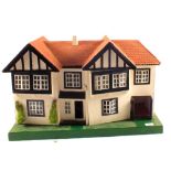 A wooden dolls house and furniture