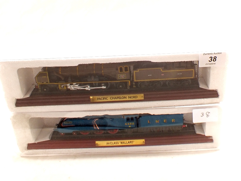 Two static model locomotives on plinths,