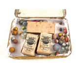 A tin with marbles including boxed Elgee