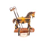 A wooden toy wheeled horse