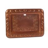 A large Arts and Crafts rectangular Copper tray with repousse fruits and foliage and stamped four