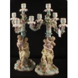 A pair of 19th Century Sitzendorf three branch candelabra with mother and child columns and applied