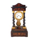 A 19th Century French Empire style ebonised mantel clock with floral inlays supported by four