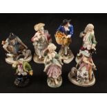 A 19th Century continental porcelain fruit seller and six other figurines
