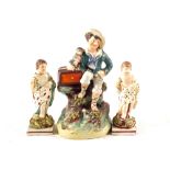 A pair of early 19th Century pearlware putto and Victorian Staffordshire organ grinder with monkey