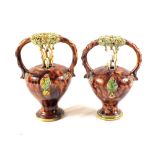 An unusual pair of Whieldon style puzzle jugs with floral appliques and green encrustation (one as