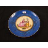 A 19th Century continental porcelain wall plate, blue ground with mother and child painting,