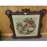 A woolwork picture of a songbird in a Victorian carved Mahogany frame,