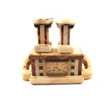 An Art Deco brown and white Onyx striking mantel clock garniture