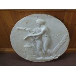 A circular plaster plaque of two classical ladies with urn and trumpets,