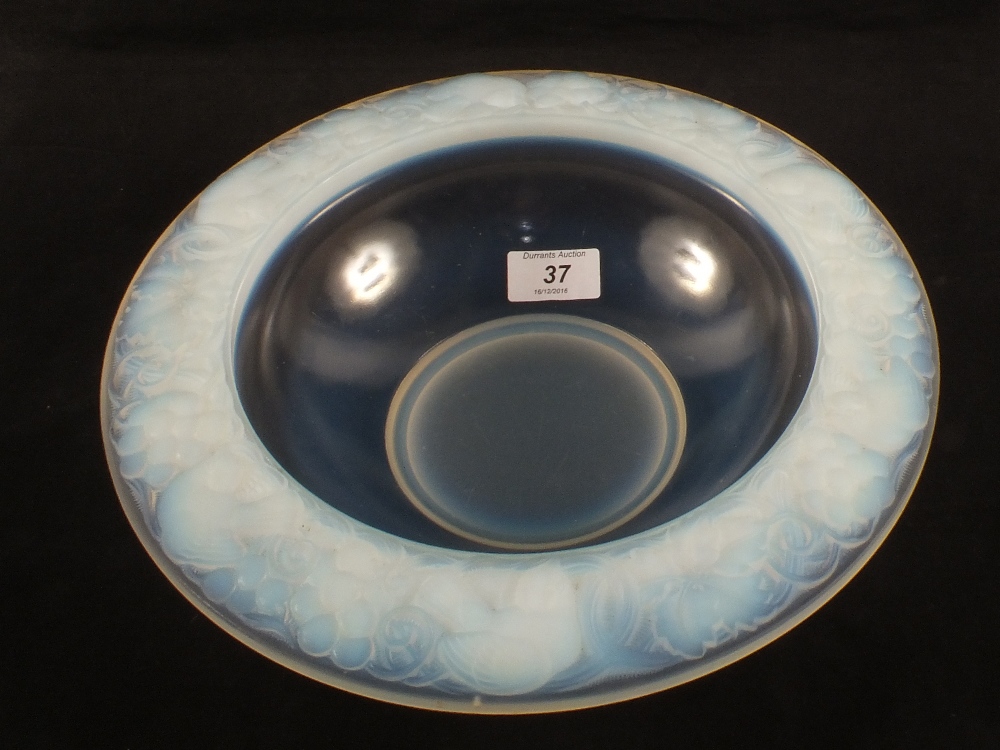A desirable French opalescent glass bowl with bird and floral moulded rim, marked P'Davesn,