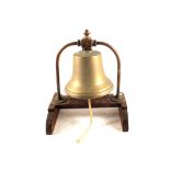 A Brass bell on wooden stand