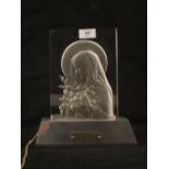 An French illuminated glass plaque with bas relief decoration of the Saint Therese,