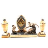 An Art Deco clock garniture in various marbles with metal seated lady and boy playing pan pipes,