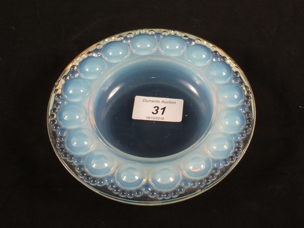 An opalescent glass dish with circular moulding,