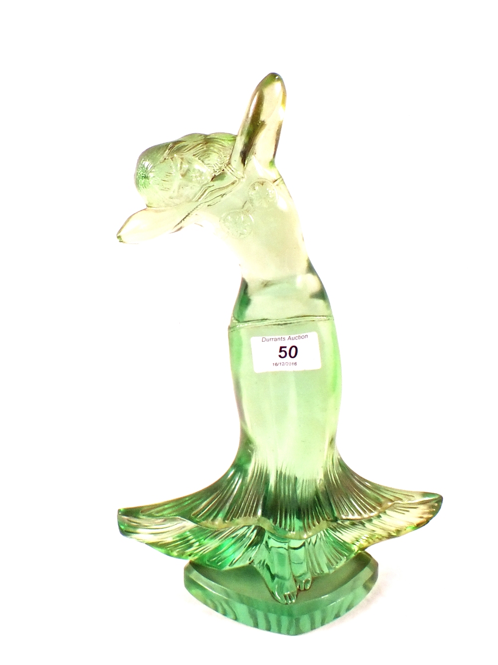 A rare French emerald green glass dancing lady with flared hem by Etling,