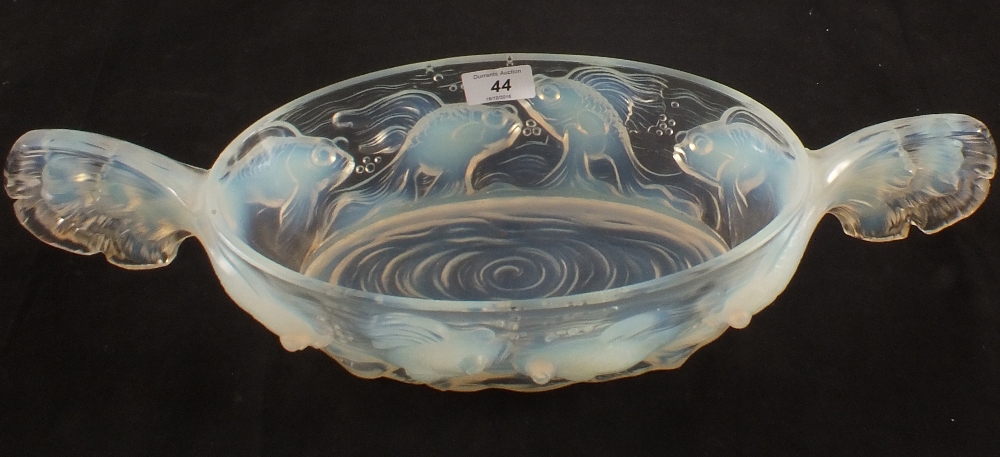 A French oval opalescent glass bowl with moulded carp design and fishtail handles,