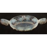 A French oval opalescent glass bowl with moulded carp design and fishtail handles,