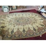 A machine made Persian pattern oval carpet,