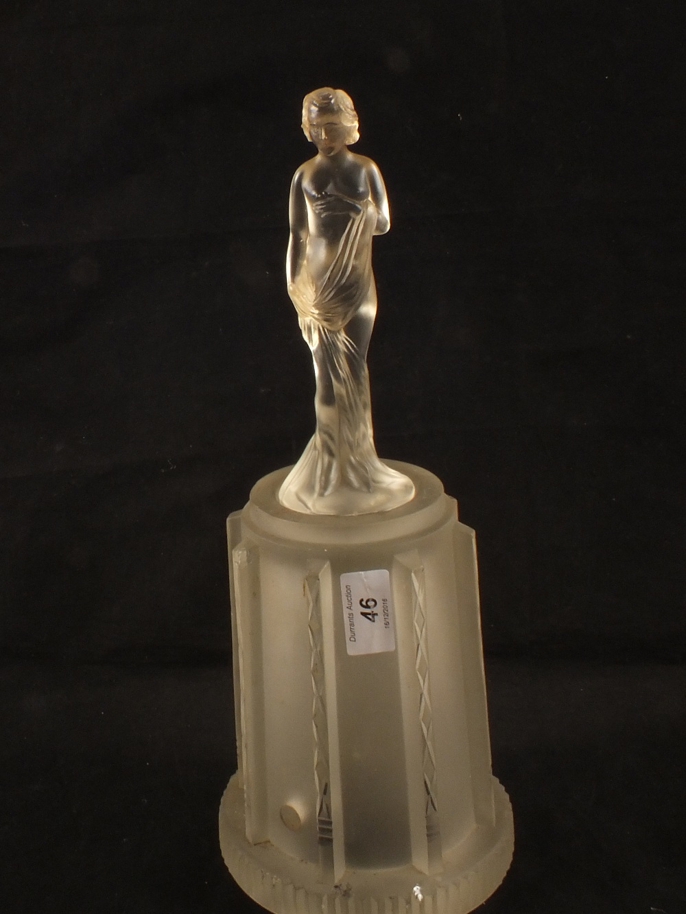 A rare German Art Deco frosted glass two piece table lamp with standing lady over shade by Sweig