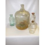 glass carboy and three large glass containers