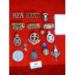 a collection of military cap badges etc