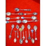 a collection of silver and silver plated souvenir spoons