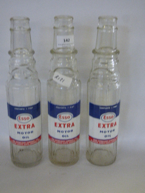 three Esso Extra motor oil bottles