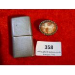 silver cased cigarette lighter and a cameo