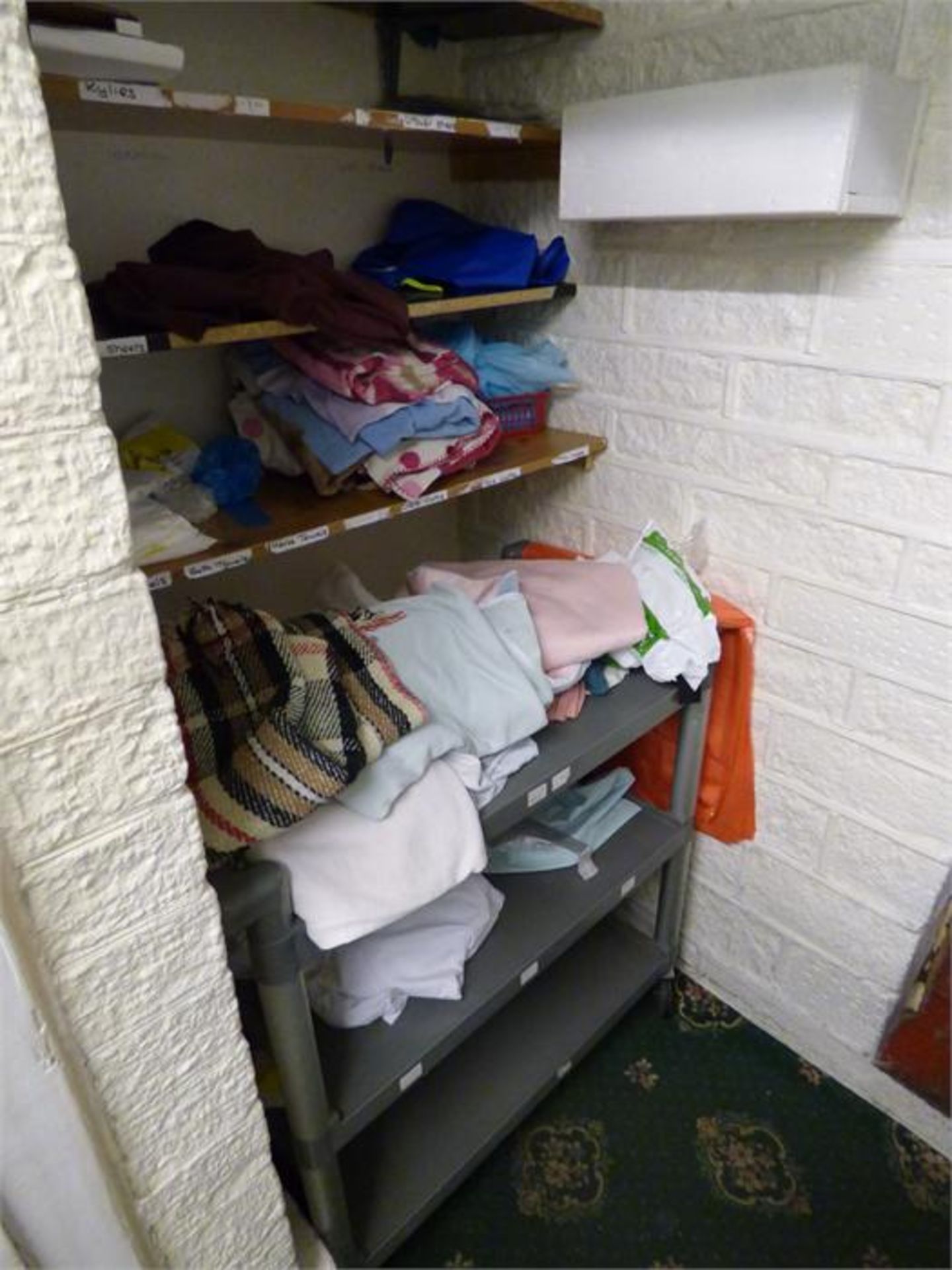 Contents of Storeroom Cupboard Which Includes; Assorted Linen, Three Tier Trolley and a Wheelchair