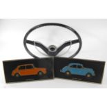 A classic Morris car steering wheel and two Unipart plastic easel plaques of Morris cars (3)