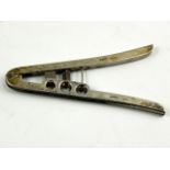 An Edward VII silver cigar cutter and pricker, of grip lever form, import marks, Andrew Barrett &