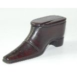 A treen snuff box carved as a shoe, early 19thC, with brass stud work, 10cm long.