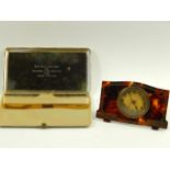 A Michelin Easel table clock, with faux tortoiseshell inlaid frame and a Jaguar Cars cigarette case,