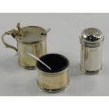 A silver three piece condiment set, of barrel form, with blue glass liners, salt cellar and spoon,