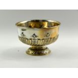 An Edward VII silver pedestal rose bowl, with semi scroll fluting and embossed leaf decoration,