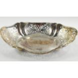 A George V Silver basket, of serpentine, oval form decorated with foliate fretwork and engraved with