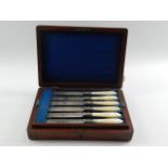 A set of six Victorian plated fruit knives and forks,  foliate engraved with mother of pearl