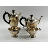 A George VI silver four piece tea set, of plain circular semi fluted design, Sheffield 1938, 33oz