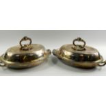 A pair of Victorian silver entree dishes and covers, with liners and drainers, of oval twin