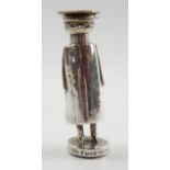 An Edwardian silver novelty pepper pot, in the form of a uniformed chauffeur, Chester 1906, 9cm