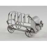 A silver plated toast rack, in the form of a veteran car.