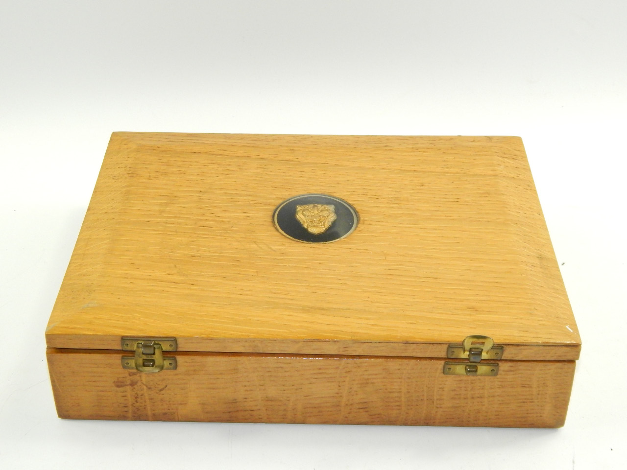 A Jaguar Cars oak box, containing place mats.