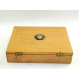 A Jaguar Cars oak box, containing place mats.