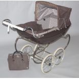 A Silver Cross pram, sprung chassis,  with a brown carriage, floral interior.