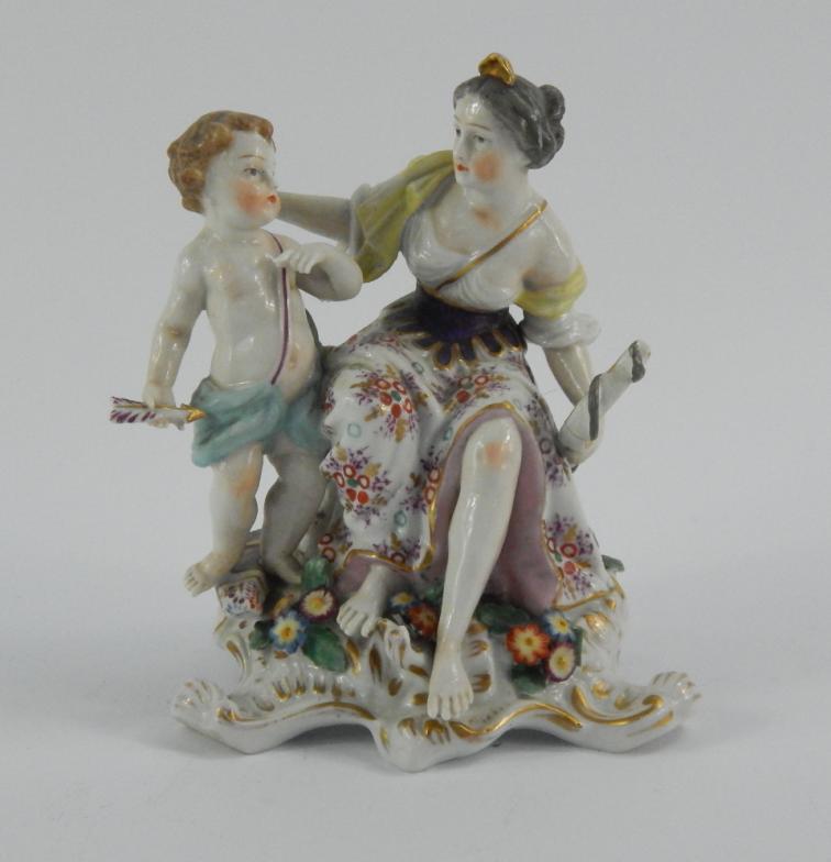 A Samson Chelsea porcelain figure group of Cupid and Psyche, late 19thC, modelled seated on a rococo
